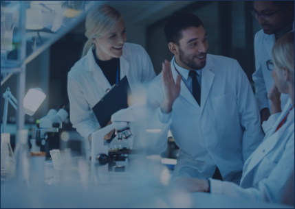 Three people in white medical uniforms working in a laboratory.